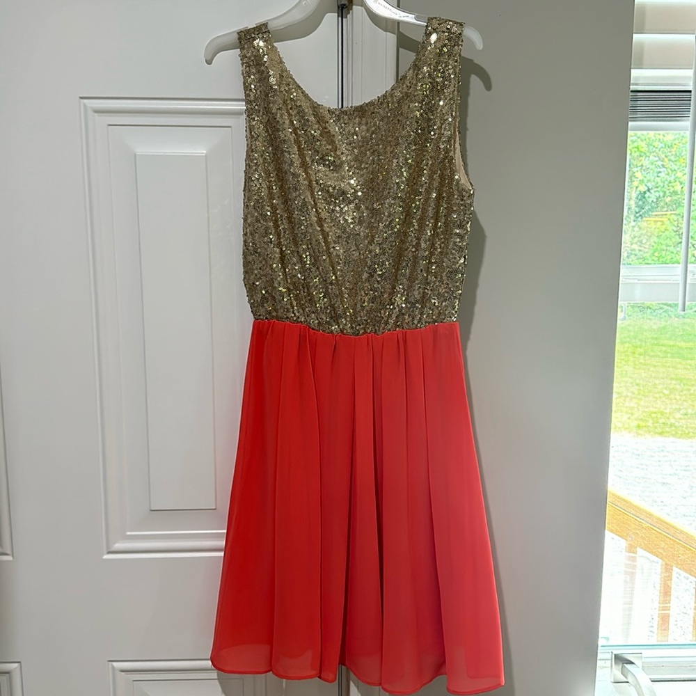NWOT party dress. Gold sequins with peace bottom. Never worn and has been in bag